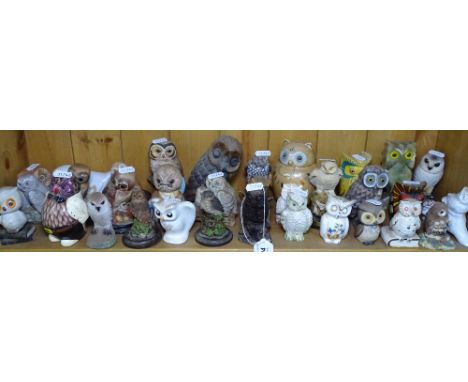 A shelf of owl ornaments