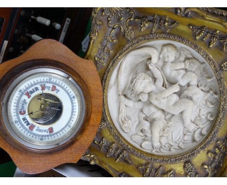 A reproduction plaque in embossed gilt frame, a barometer and a wall clock
