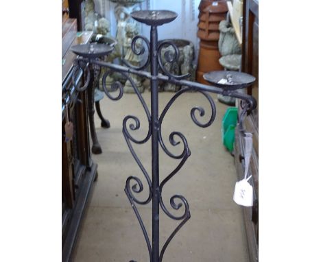 A wrought-iron floor standing candelabra