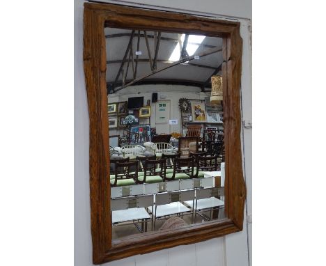 A rustic framed hanging wall mirror