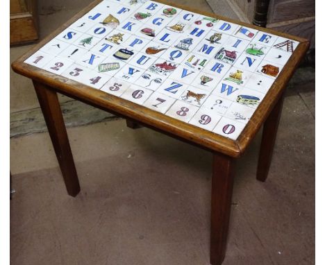 A mid-century oak and alphabet tile top coffee table, signed "Potzick?", W55cm
