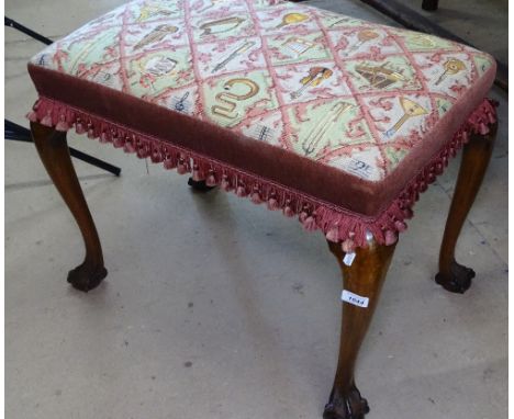 An Edwardian mahogany and upholstered music stool, raised on cabriole legs, claw and ball feet, W65cm