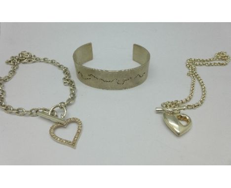 A silver bangle and two silver neck chains, 91g