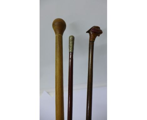 A Boys Brigade stick, a swagger stick with a carved pheasant's head and a pacing stick