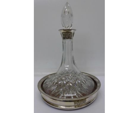 A silver rimmed ships decanter with silver coaster, Birmingham 1972, with box