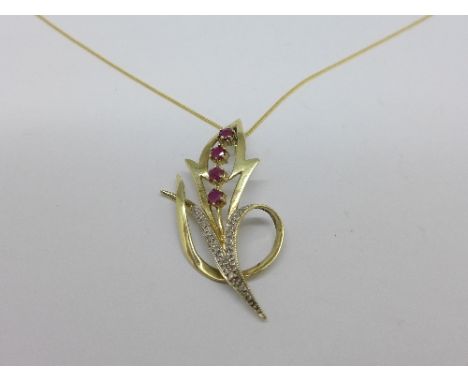 A 9ct gold, ruby and diamond pendant on a silver chain, weight of pendant 3.5g