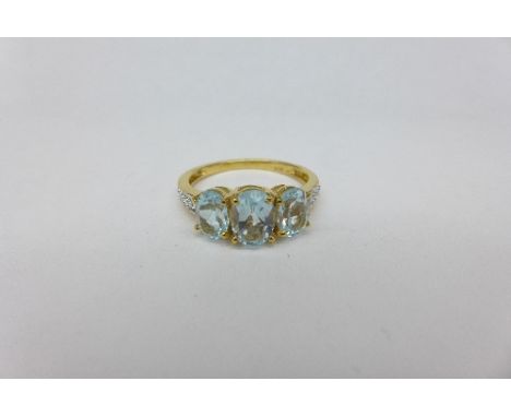 A silver gilt topaz trilogy ring, R