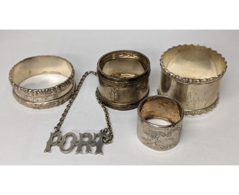 Two sterling silver napkin rings together with two white metal smaller napkin rings, and a port decanter label, 73.4gLocation