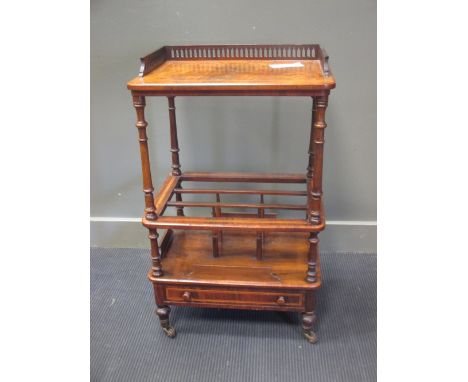 A Victorian figured walnut canterbury whatnot with galleried top shelf and drawer, on turned legs and casters, 93 x 56cm  