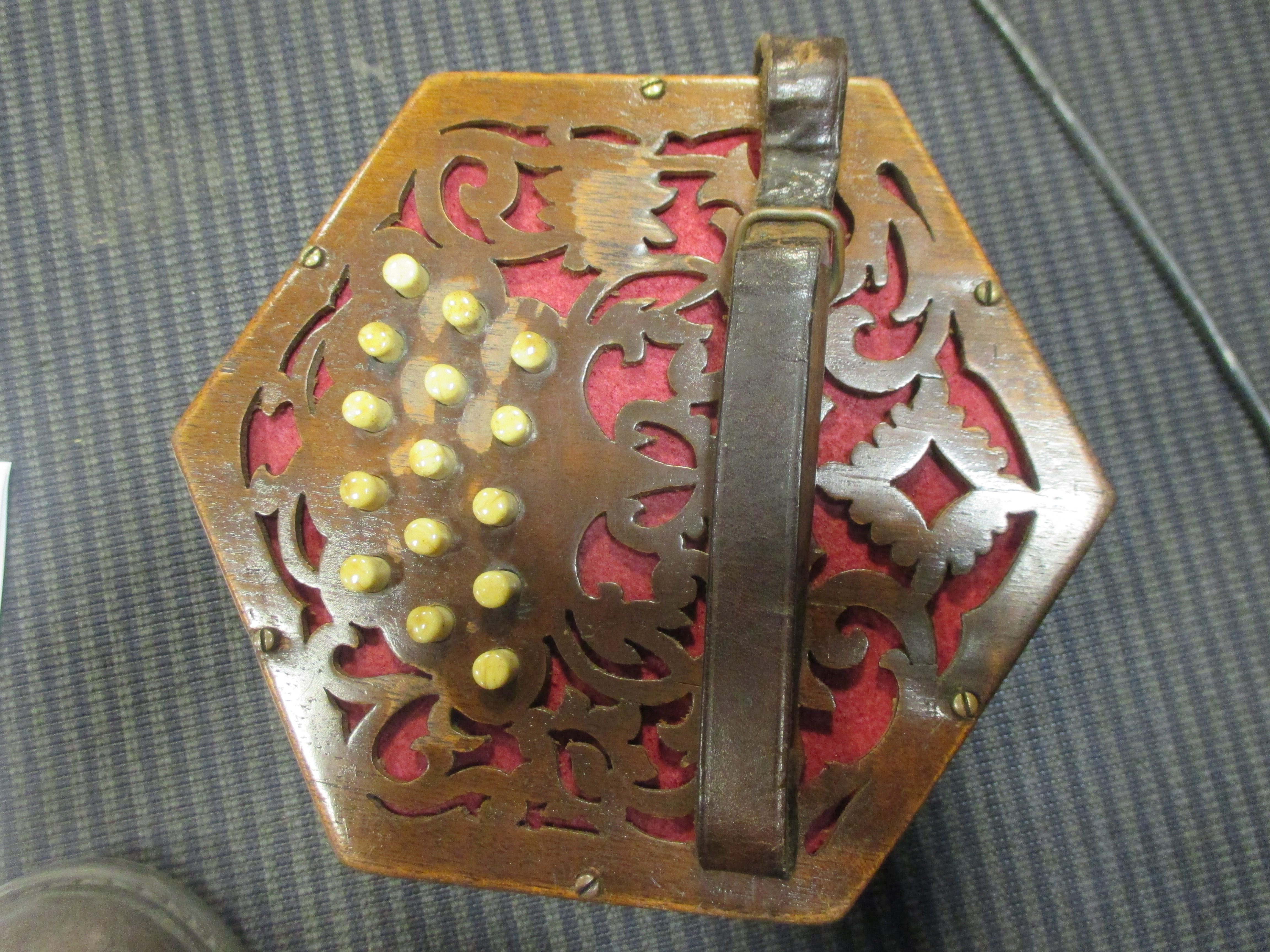 A concertina music box together with another, and two pairs of leather