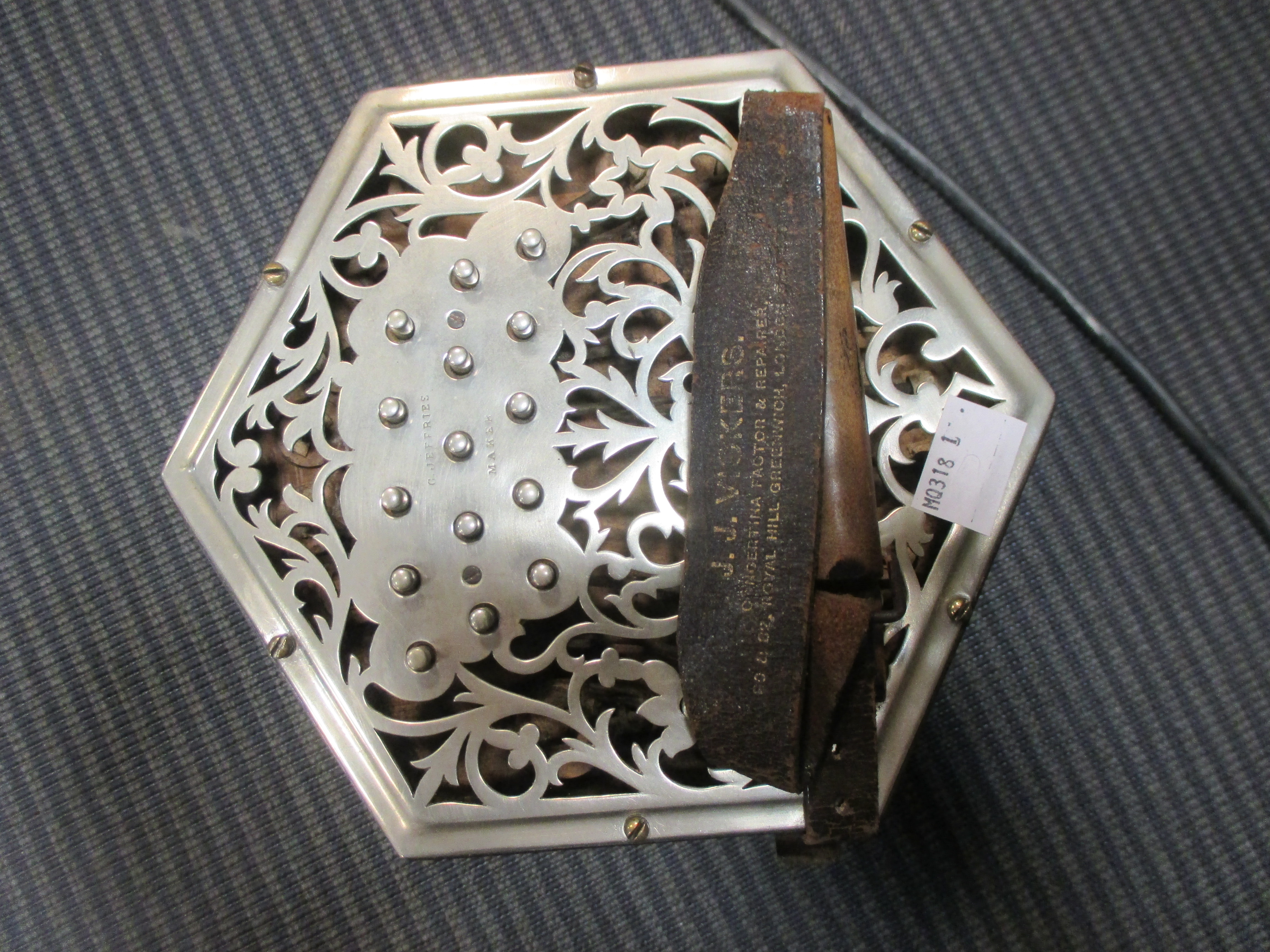 A concertina music box together with another, and two pairs of leather