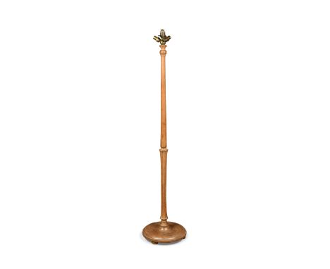 An early twentieth century pale oak standard lamp, with original triple bulb holder, fluted and waisted column with dished ci