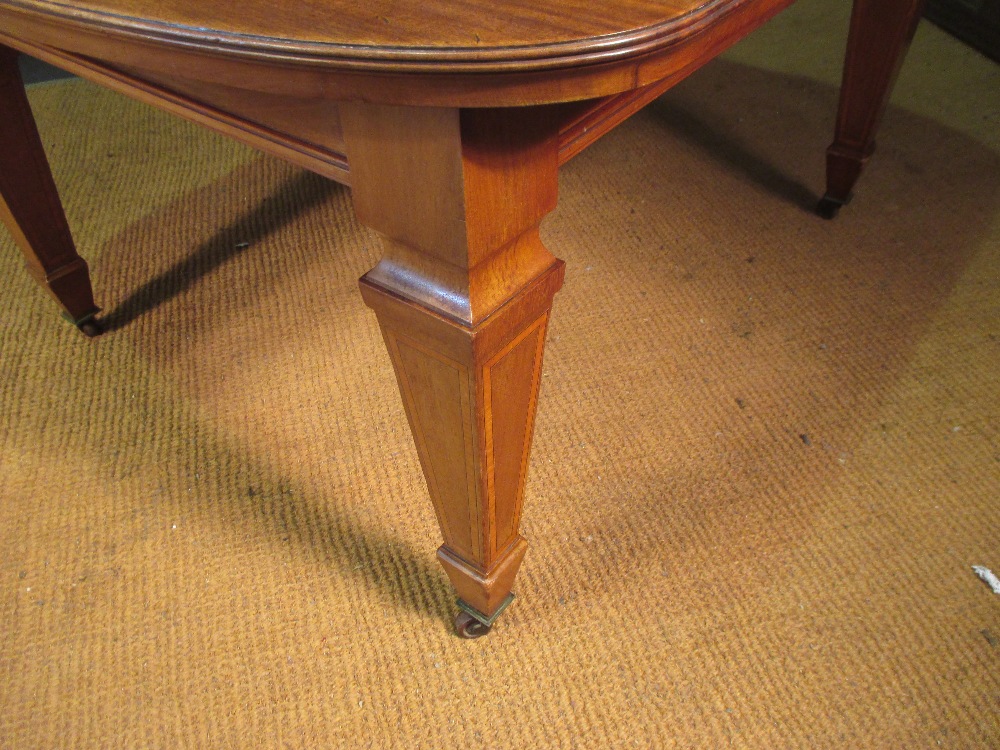 WITHDRAWN A late Victorian mahogany extending dining table with three