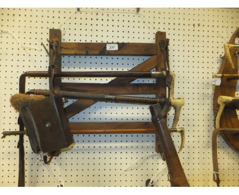 A wooden whip rack in the form of a four bar gate, together with a three various crops / whips, a leather hunting horn holder