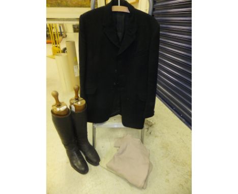 A pair of black leather riding boots with wooden trees, together with two pairs of jodhpurs and a gentleman's black hunting j