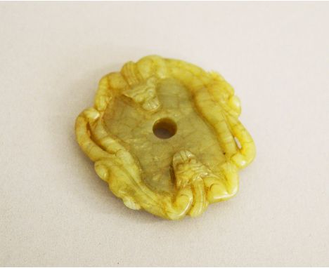 A Chinese Jade carving with carved bat decoration. 5cm diameter.
