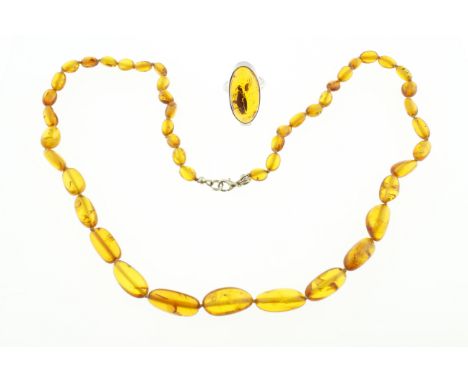 A silver amber ring size N, together with an amber beaded necklace approx 24"