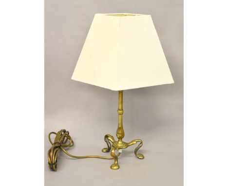 A brass lamp with tripod base and shade. Height 32cm.