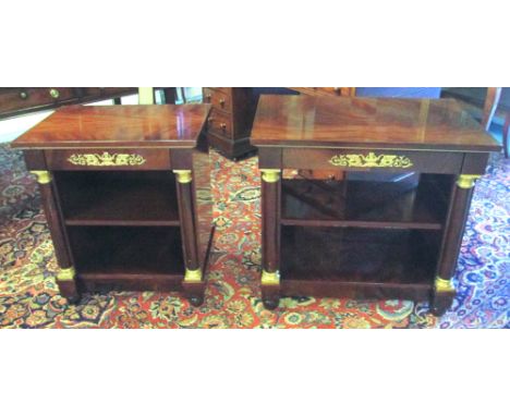 BEDSIDE TABLES, two matching Empire style mahogany with a short drawer having an ornate swan decorated mount over a shelf fla