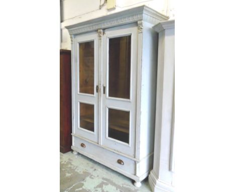 ARMOIRE, distressed grey painted with two glazed doors, interior hooks and shelf and long drawer at the bottom, 125cm x 52cm 