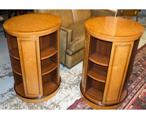 REVOLVING BOOKCASES, a pair, bird's eye maple with ebonised detail, 99cm x 60cm. (some shelf supports lacking)