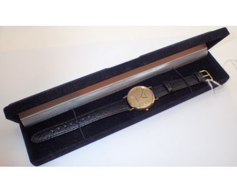 Gents boxed 9ct gold Bulova dress wristwatch with champagne dial and black leather strap