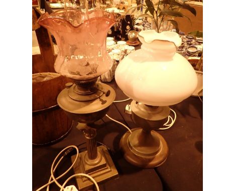 Two brass and aluminium oil lamps converted to electric CONDITION REPORT: Cranberry shade has no visible cracks or chips, the