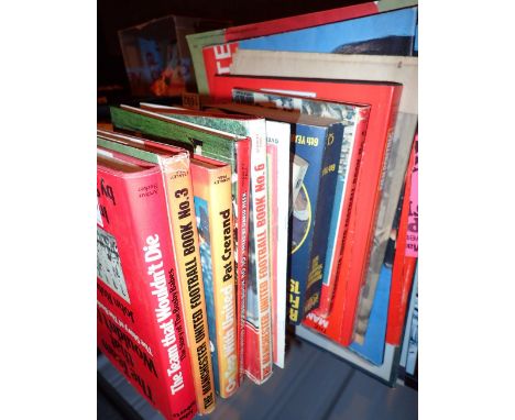 Shelf of Manchester United books and posters 