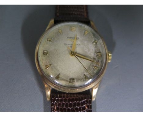 A 9ct gold cased Longines gentleman's wristwatch, the circular silvered dial with arrow head markers and Arabic numerals at 1