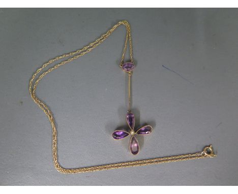 A 9ct yellow gold necklace with four point amethyst pendant, seed pearl to centre with amethyst above - weight approx 3.2 gra