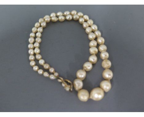 A pearl necklace with sixty pearls graduating in size from 8mm to 2mm - Length approx 44cm