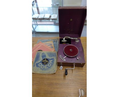 A Polo Odeon wind up portable gramophone with four records - working