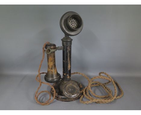 An early candlestick telephone in corroded condition