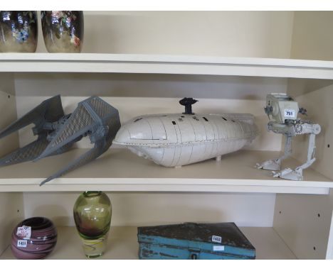 Three Star Wars toys including an ATST Rebel Transport ship and a Tie Fighter 