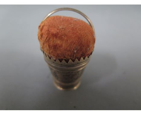 A white metal pin cushion in the form of a pail