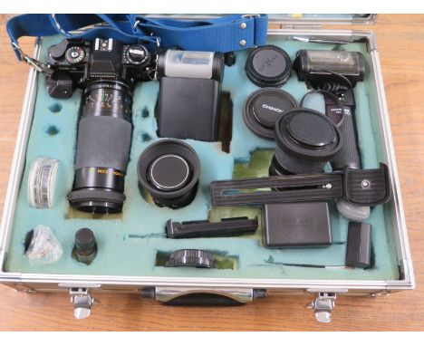 Chinon CE-5 Camera together with a range of lenses, Hanimex & Chinon flashes and other items housed in metal flight case