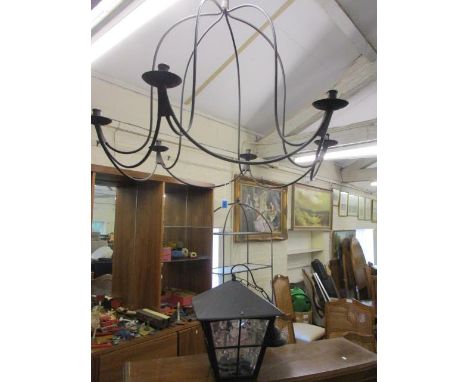 A wrought iron, six armed ceiling candelabra together with a black metal coach house light 