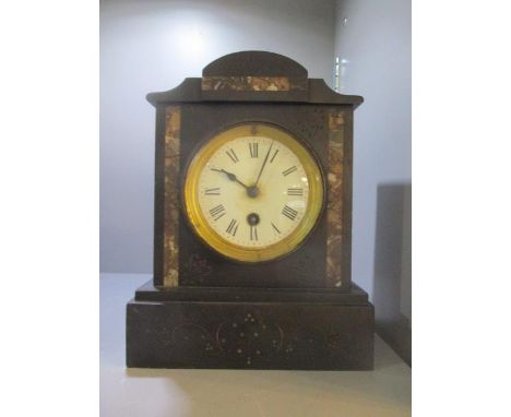 A Victorian black slate mantel clock having a white enamel dial and Roman numerals, 9 1/4"h x 7 1/4"w 