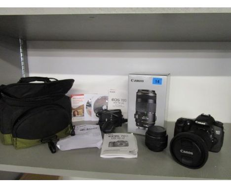 A Canon E05 70D digital camera with additional lens, dust caps, booklets etc to include a boxed Canon EF 70-300mm f/4.5.6 IS 