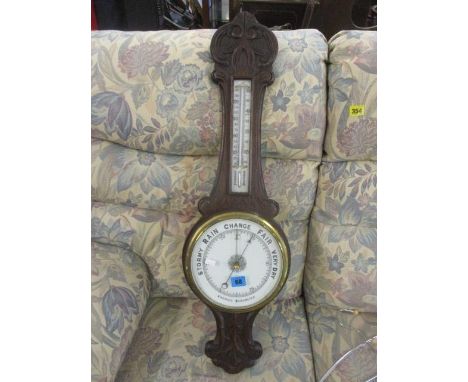 An early 20th century oak carved Aneroid barometer, 32 3/4"h 