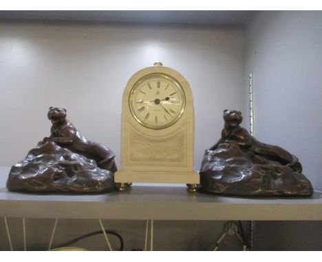 Two reproduction brass bookends in the form of tigers, together with a modern mantle clock 