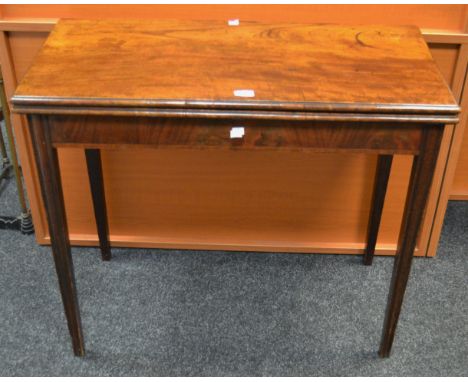A George III mahogany fold over card table fluted supports