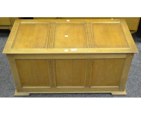 A contemporary light oak blanket box, hinged top, crossbanded fluted panels to frieze 