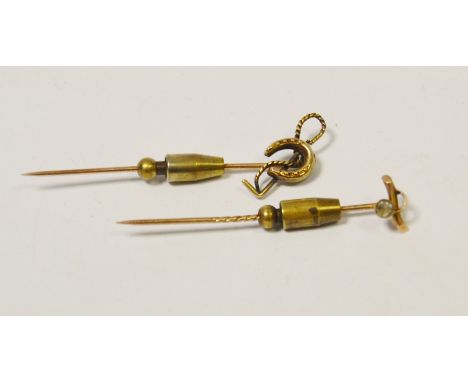 A 15ct gold stick pin , riding crop and horse shoe terminal ; another (5.6g approx.)