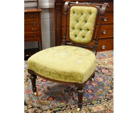 A Victorian mahogany button-back nursing chair, turned supports, ceramic casters