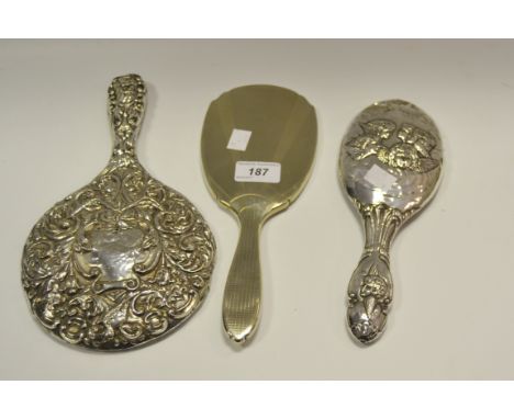 A silver backed hand mirror impressed with Reynolds Angels Birmingham 1904; another impressed with scrolling foliage Birmingh