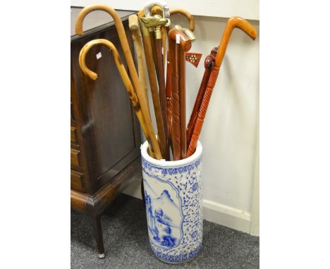 A contemporary blue and white stick/umbrella stand; a fruitwood walking stick; others