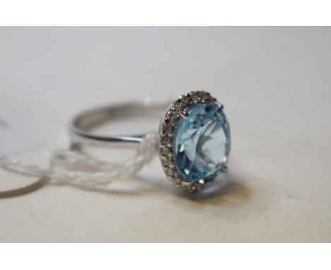 A silver and blue topaz ring, with a matching pair of earrings Condition report Report by NG

Approx. ring size R.  

Stone a