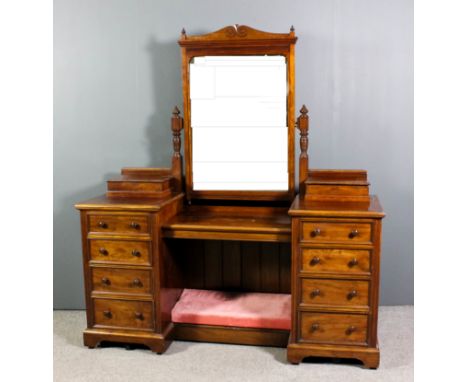 A Victorian mahogany drop centre dressing table, fitted central drawer on turned uprights, the pedestals each with lidded com