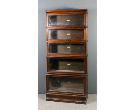 A Globe Wernicke stained wood five tier sectional bookcase, each tier enclosed by a rising glazed panel, on plinth base, 34in